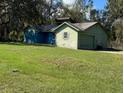 Single story home with a mature lawn and attached garage needs some TLC and is waiting for renovation at 1440 Walker Rd, Lakeland, FL 33810