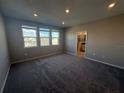 Spacious bedroom bathed in natural light, enhanced by plush carpeting and neutral walls at 1227 Teal Creek Dr, Saint Cloud, FL 34771