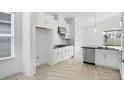 Well-lit kitchen featuring stainless steel appliances and white cabinets at 5267 Stone Ridge Pl, St Cloud, FL 34771