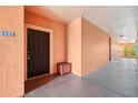 Exterior entrance with a dark brown door, and a charming wooden box at 5536 Metrowest Blvd # 8-304, Orlando, FL 32811