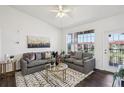 Bright living room features modern decor, large window, and ceiling fan at 5536 Metrowest Blvd # 8-304, Orlando, FL 32811