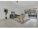 Inviting living room with neutral decor, tile flooring, and sliding glass doors offering pool views and natural light at 1121 Trotwood Blvd, Winter Springs, FL 32708
