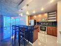 Modern kitchen featuring a breakfast bar with seating, stainless steel appliances and ample cabinet space at 155 S Court Ave # 1610, Orlando, FL 32801