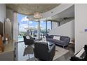 Modern living room featuring floor-to-ceiling windows with stunning views and contemporary furnishings at 155 S Court Ave # 1610, Orlando, FL 32801
