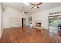 Spacious living room boasts vaulted ceiling, fireplace, hardwood floors, and large windows offering ample natural light at 5100 Linwood Cir, Sanford, FL 32771