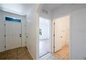 Bright foyer featuring tile flooring, a neutral palette, and open access to multiple rooms at 2950 Gibraltar Blvd, New Smyrna Beach, FL 32168