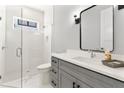 Spa-like bathroom with a glass shower and gray vanity at 1840 Biscayne Dr, Winter Park, FL 32789