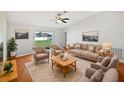 Bright living room featuring neutral furniture and hardwood floors at 7856 Habersham Dr, Lakeland, FL 33810
