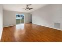 Bright living room featuring hardwood floors and sliding glass doors at 7856 Habersham Dr, Lakeland, FL 33810