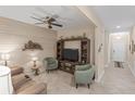 Cozy living room featuring a ceiling fan, TV, and stylish décor at 2877 Attwater Loop, Winter Haven, FL 33884