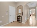 Bright entryway with tile flooring, a small table, and access to other rooms at 313 Kensington Dr, Davenport, FL 33897