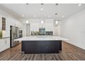 Spacious kitchen featuring a large island, stainless steel appliances, and modern white cabinetry at 2132 Antilles Club Dr, Kissimmee, FL 34747