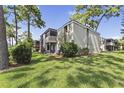 A condo's exterior boasts a well-manicured lawn and private screened balcony at 115 Springwood Cir # C, Longwood, FL 32750