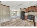 Kitchen open to the living room featuring black appliances and lots of light at 9100 Sw 32Nd Ct, Ocala, FL 34476