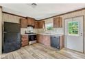 Efficient kitchen with modern black appliances and wood-look flooring at 9100 Sw 32Nd Ct, Ocala, FL 34476