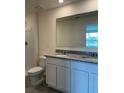 Bathroom with double vanity, granite countertops, and a large mirror at 670 Moscato Dr, Holly Hill, FL 32117