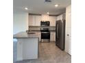 Modern kitchen featuring white cabinets, granite countertops, and stainless steel appliances at 670 Moscato Dr, Holly Hill, FL 32117