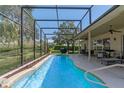 Relaxing screened-in pool with a patio area, perfect for entertaining and enjoying the outdoors at 404 Hightower Dr, Debary, FL 32713