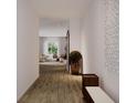 Bright hallway with wood floors that leads to a spacious living area with lots of natural light at 1102 East Pkwy, Deland, FL 32724