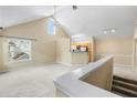 Light-filled living room with vaulted ceiling, a ceiling fan, and a partial view of the kitchen at 3383 Westchester Square Blvd # 204, Orlando, FL 32835