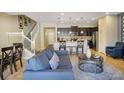 Open-concept living space with modern furnishings and staircase access to the second floor at 8924 Adriatico Ln, Kissimmee, FL 34747