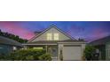 House exterior at night with a beautiful sunset in the background at 1452 Brookebridge Dr, Orlando, FL 32825