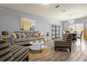 Bright living room features stylish furniture and wood-look floors at 1625 Reflection Cv, Saint Cloud, FL 34771