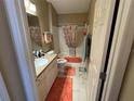 Clean bathroom with tub shower, updated vanity, and coral accents at 1631 Edisto Ln, The Villages, FL 32162