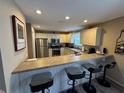 Modern kitchen featuring stainless steel appliances and an island with seating at 1631 Edisto Ln, The Villages, FL 32162