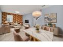 Open living space featuring modern decor, stylish furniture, and a decorative accent wall at 7642 Fairgrove Ave, Windermere, FL 34786