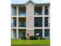Exterior of a multi-story building with multiple balconies and well-maintained landscaping at 1990 Erving Cir # 201, Ocoee, FL 34761