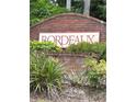 Community sign for Bordeaux, surrounded by lush green landscaping at 1990 Erving Cir # 201, Ocoee, FL 34761