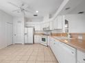 Spacious kitchen featuring white cabinets, tiled floor, and modern appliances at 20505 Queen Alexandra Dr, Leesburg, FL 34748
