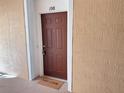 Condo front door with welcome mat, textured wall and the number 108 above the door at 3224 Dante Dr # 108, Orlando, FL 32835