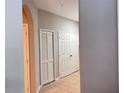 Hallway with neutral paint, tile floor, and a linen closet and other closets at 3224 Dante Dr # 108, Orlando, FL 32835