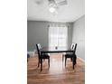 Inviting dining room featuring a ceiling fan, grey walls, and a dark wood table set for two at 2495 Sedgefield Ave, Deltona, FL 32725