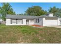 Charming single-story home with white siding, dark shutters, and a well-maintained front yard at 2495 Sedgefield Ave, Deltona, FL 32725