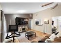 Spacious living room featuring hardwood floors and a large TV at 2495 Sedgefield Ave, Deltona, FL 32725