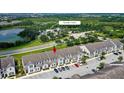 Aerial view of townhouses near a lake and amenity center at 154 Captiva Dr, Davenport, FL 33896