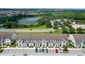 Aerial view of townhouses with parking and a nearby lake at 154 Captiva Dr, Davenport, FL 33896