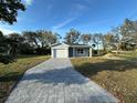 Charming single-story home with a well-manicured front yard and a gray brick driveway at 29 W 17Th St, Apopka, FL 32703