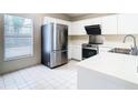 Modern kitchen with stainless steel appliances and white cabinetry at 2906 Woodruff Dr, Orlando, FL 32837
