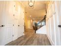 Spacious entryway with wood-look floors and white wainscoting at 790 Candlebrush Ln, Lake Mary, FL 32746