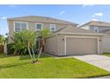 Inviting two-story home with lush landscaping and a spacious two-car garage at 132 Spanish Bay Dr, Sanford, FL 32771