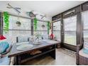Cozy sunroom with wicker furniture and nautical-themed decor at 100 E Oak Terrace Dr # G1, Leesburg, FL 34748
