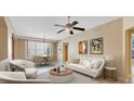 Inviting living room featuring a ceiling fan, modern furnishings, and lots of natural light at 913 Lotus Vista Dr # 101, Altamonte Springs, FL 32714