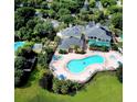 Aerial view showing resort-style pool, clubhouse, and lush landscaping at 113 Rogues Retreat, Davenport, FL 33897