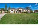 Single-story home exterior with stone accents and manicured lawn at 13707 Calle De Ora Ct, Clermont, FL 34711