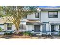 Close-up of a two-story townhome featuring a well-maintained lawn and a classic facade at 2722 Graduate Ct, Orlando, FL 32826