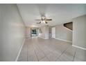 Bright, spacious living room featuring tile flooring and a ceiling fan at 2722 Graduate Ct, Orlando, FL 32826